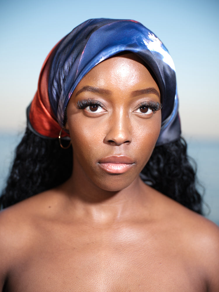 artistic, luxurious silk scarf with Jamaican sunset beach scene in blue and orange tones, made in Canada