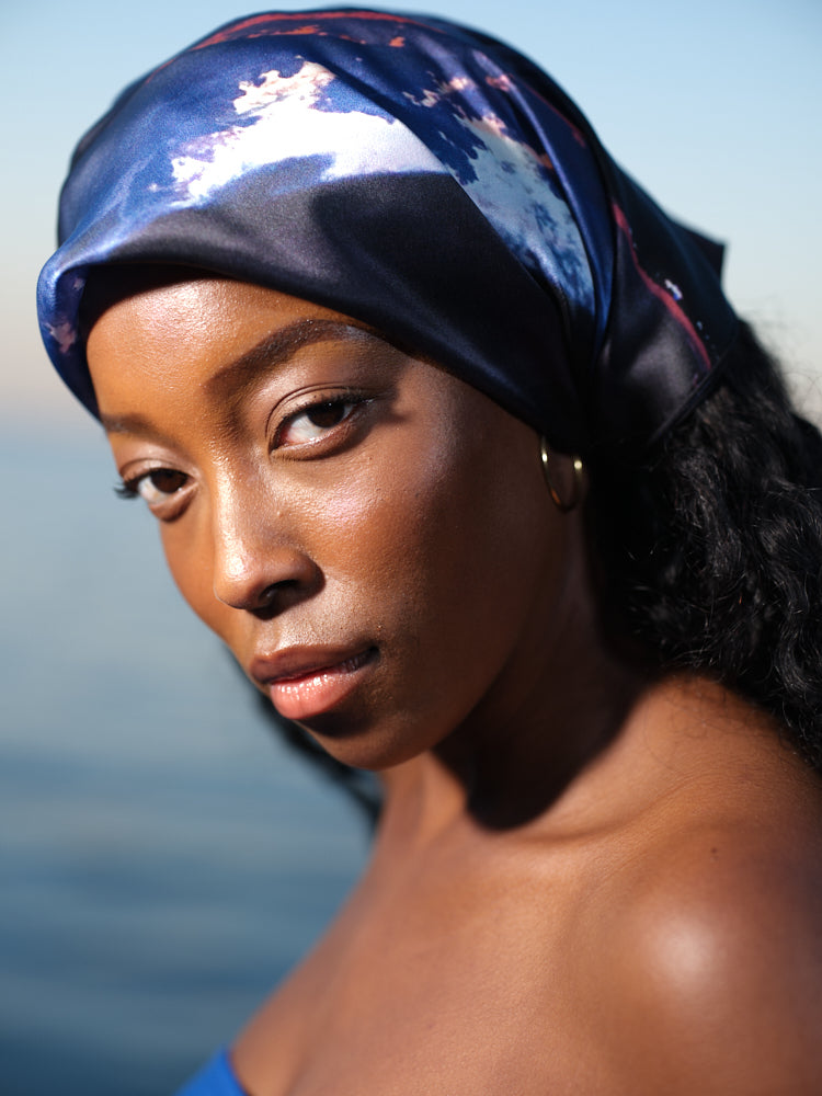 artistic, luxurious silk scarf with Jamaican sunset beach scene in blue and orange tones, made in Canada