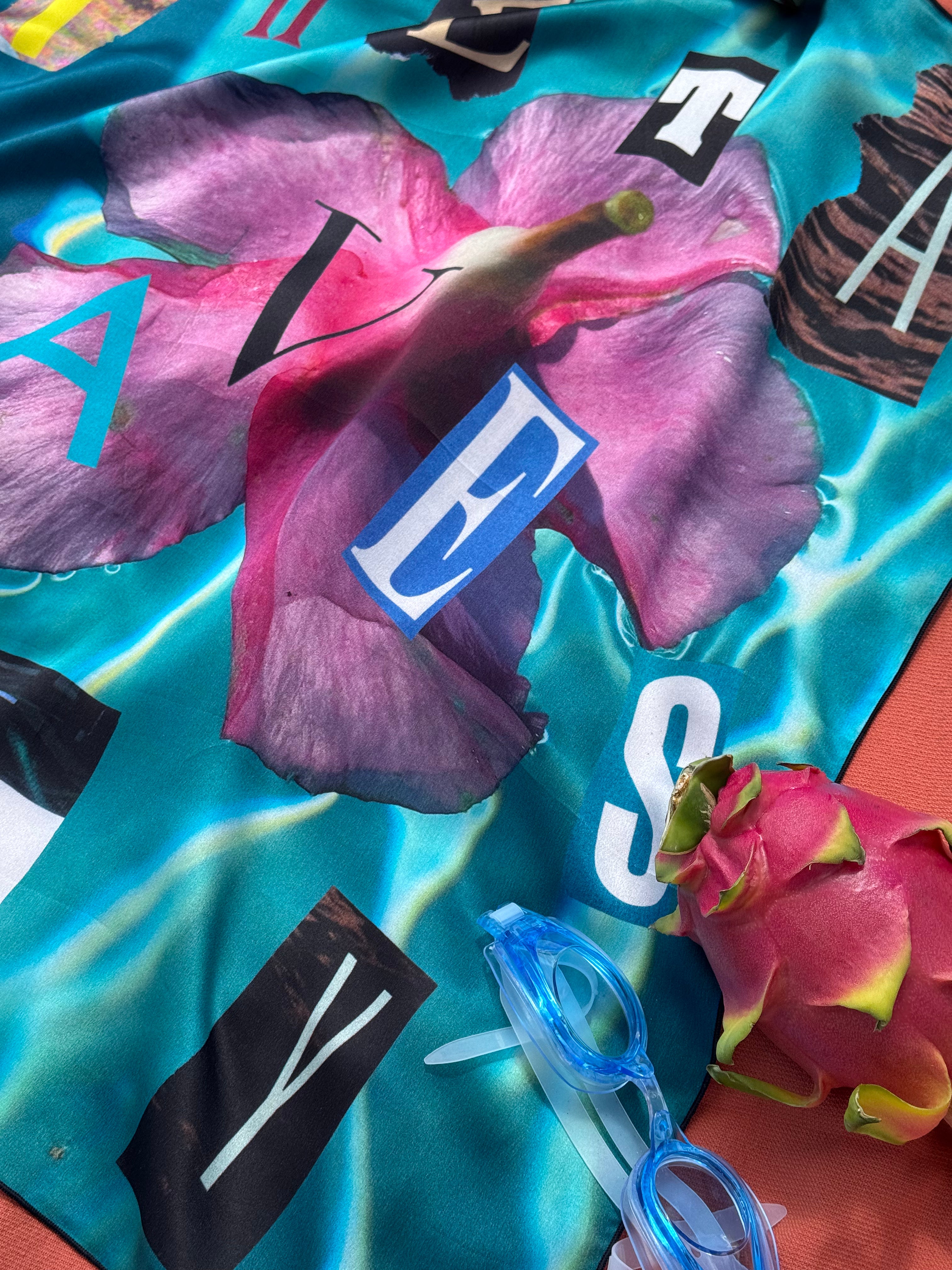 artistic, luxurious silk scarf featuring stunning pinks and blues with poetic collaged text, made in Canada