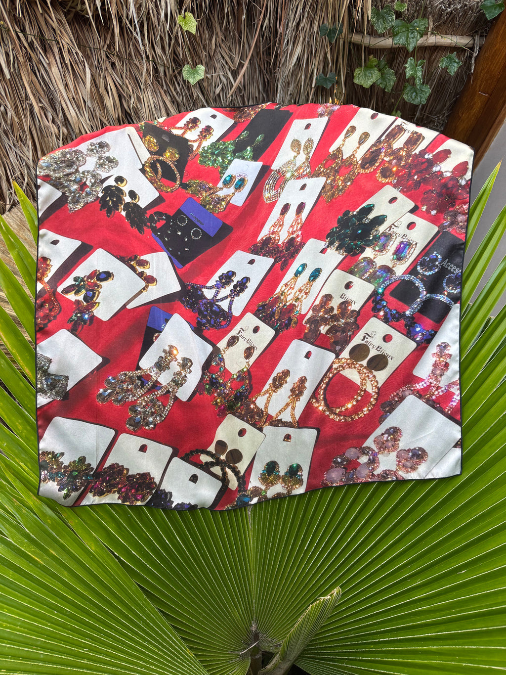 artistic, luxurious silk scarf with original photograph of colourful costume jewellery earrings on red background, made in Canada