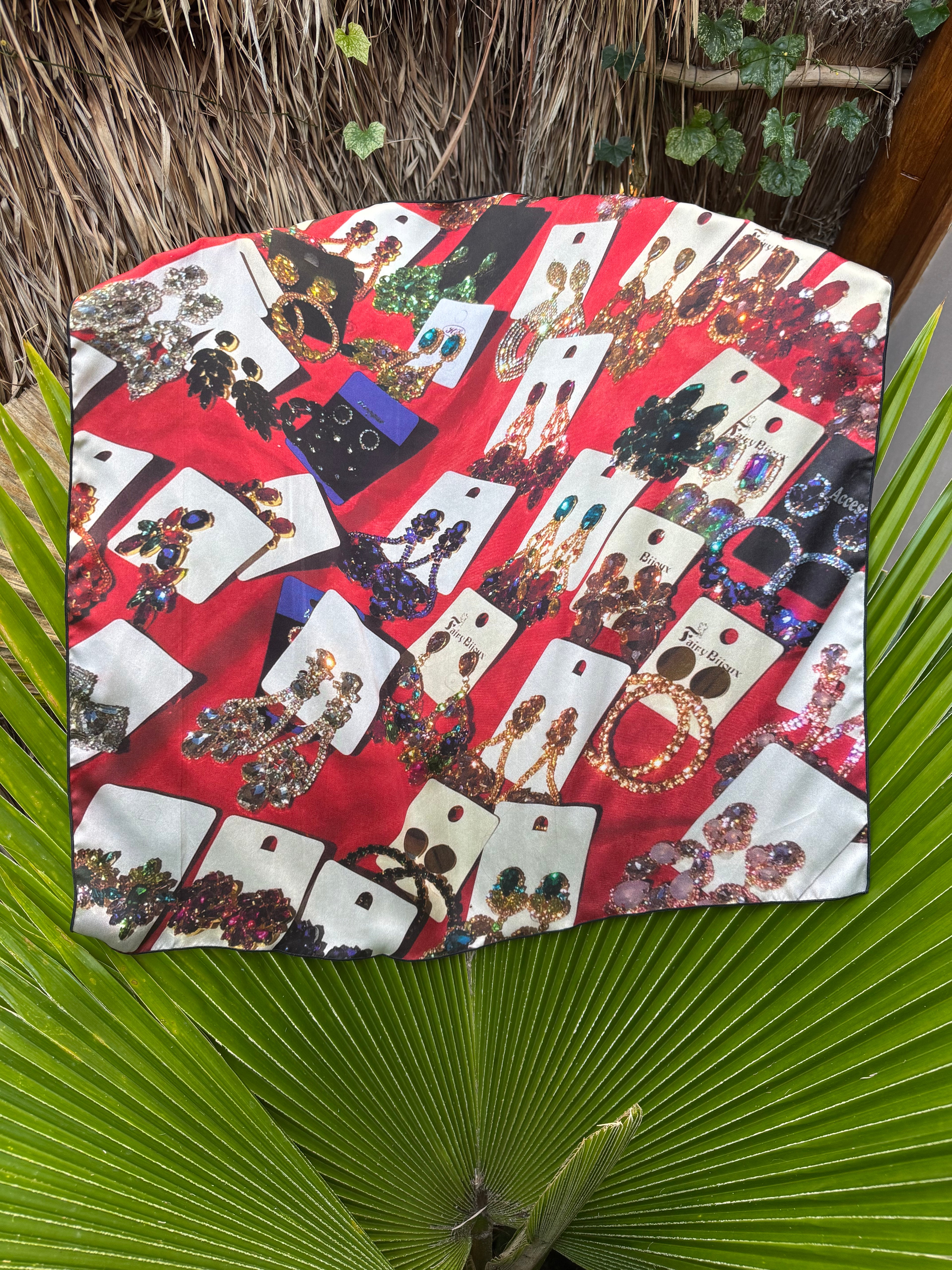 artistic, luxurious silk scarf with original photograph of colourful costume jewellery earrings on red background, made in Canada